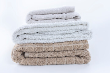 Fototapeta na wymiar Stack of folded clean soft towels on white