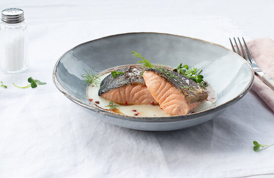 Salmon with mashed potatoes with seasonings on ceramic plate