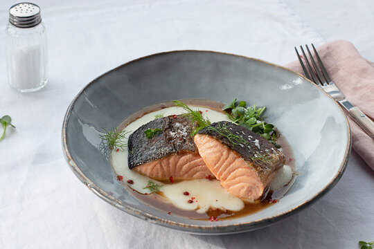 Salmon with mashed potatoes with seasonings on ceramic plate