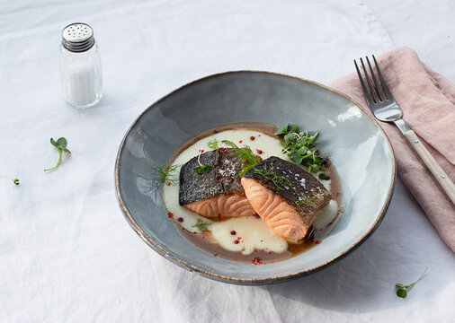 Salmon with mashed potatoes with seasonings on ceramic plate