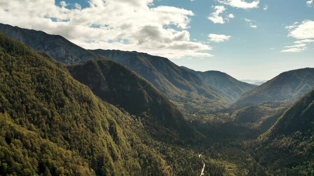 Aerial Push in Shot of Beautiful Large Valley Between Mountains and Hills in Midday, Autumn Forest. Kamnik, Slovenia.
