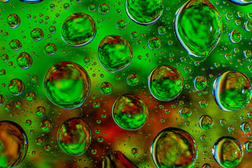 Water droplets on a glass in form of lenses with a colourful background. Wallpaper for screen. Abstract background.