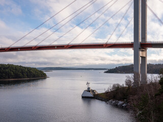 Part of suspension bridge to Tjörn island in Sweden. Pylons and cables over water strait.