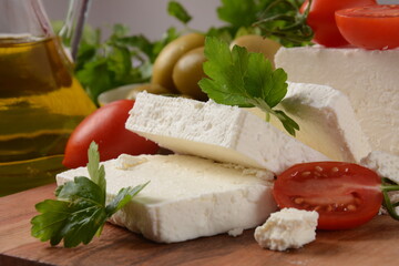 Feta cheese, olives and cherry tomatoes, green herbs and olive oil. Greek snack