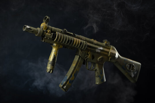 mp5 submachine gun isolated on a dark background in smoke