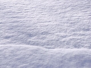 Blue white snow winter background. Snowy wavy texture. Snowdrift in snowy field. 