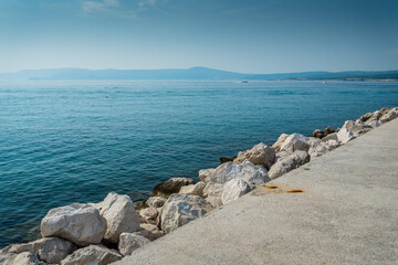 The quay of Crikvenica with stones under blue sky. Crikvenica is a popular holiday resort in...