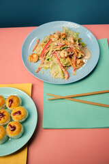 noodle and sushi rolls on a color background, minimalism