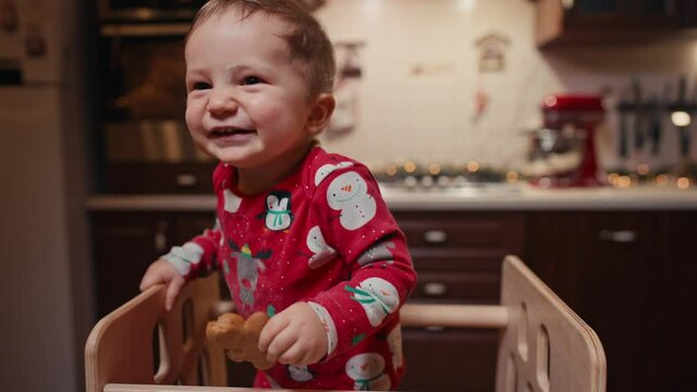 baby boy in pajamas in Christmas kitchen. High quality photo