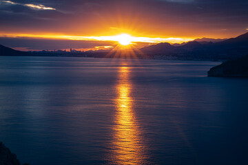 Sunset over the Mediterranean Sea and the city of Benidorm, viewed from Calp