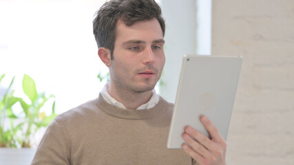 Portrait of Video Call on Tablet by Man in Office