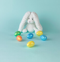 Colorful Easter eggs and a knitted rabbit in the background.