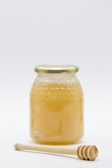 honey jar and wooden honey spoon