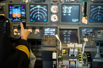 The hands of a female pilot at the helm of an airplane. Caucasian woman in flight simulator.