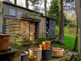 January, and the log store and dormant garden utensils on the moorland smallholding © Fencewood studio