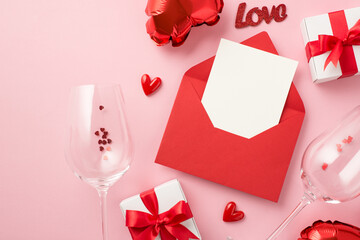 Top view photo of valentine's day decorations open red envelope with card gift boxes inscription love wineglasses with confetti heart shaped balloons on isolated pastel pink background with copyspace