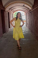 Fototapeta na wymiar A young woman with brown hair, in a yellow dress