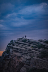 silhouette of a person standing on a rock