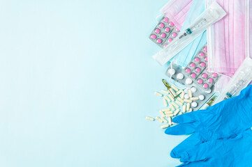 The conception of paid medicine and healthcare. Money, pils, medicine mask and gloves. Light blue backgroud. Corona virus and medicine. Using mask and pils. Mock up.