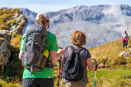 Mother and daughter hiking in the mountain of Italian Alps. Dolomites - Sassolungo, South Tyrol. Italy 