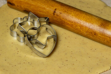Making homemade cookies. Cookie cutters on rolled dough. Making shortbread cookies