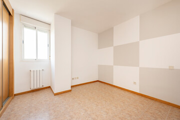 Empty room with wall painted in pictures, built-in wardrobe with sliding doors