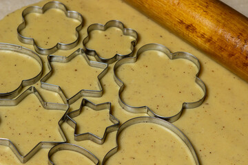 Making homemade cookies. Cookie cutters on rolled dough. Making shortbread cookies