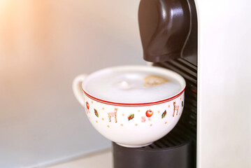 A cup of coffee in a coffee machine 