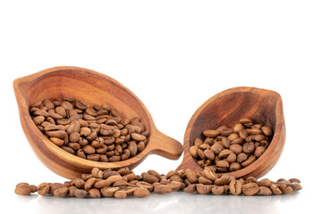Several fragrant freshly roasted coffee beans with two wooden cups, close-up, isolated on white.
