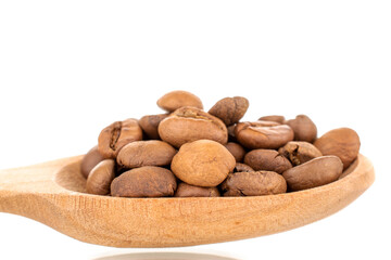 Several fragrant freshly roasted coffee beans with a wooden spoon, close-up, isolated on white.