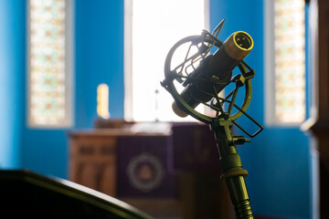 Close up studio condenser microphone on stand and anti-vibration mount. Recording studio, voice...