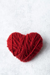 Red heart made by hand from yarn, love symbol for Valentine's day.