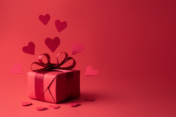 Red hearts flying from gift, present for Valentine's Day and birthday.