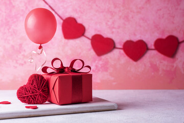Red heart, balloon, gift for birthday or Valentine's day on pink background.
