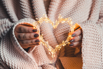 glowing heart in the hands of a woman. Happy Valentine's day - 479219413