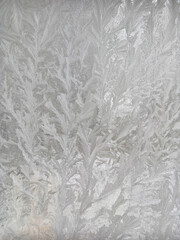 Icy frost patterns on the glass. Severe frost.