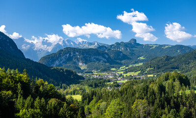 Idyllic summer alpine landscape with a small village and in the background the Loferer Steinberge,...