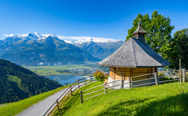 Small mountain chapel in Zell am See, in the background the impressive snow-covered Kitzsteinhorn, Salzburg, Austria, Europe