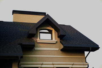 attic window. modern chalet roof with attic windows. Window on the roof of the house