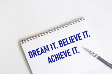 Obraz premium Dream. Believe it. Achieve this. Inspirational motivational quote on notepad and white background.