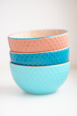 three multi-colored ceramic bowls on a white background
