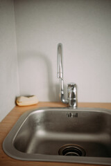 kitchen metal faucet above the sink. kitchen utensils