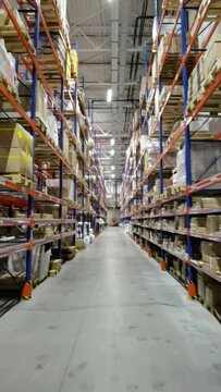 Huge distribution warehouse with high shelves and loaders.