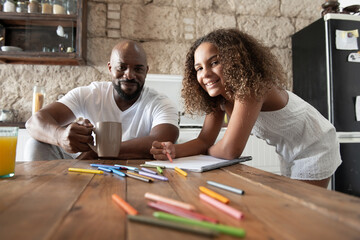 multiracial parental family sharing moments in the kitchen of their home