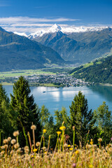 Ship sails over the idyllic lake Zell am See in a summer alpine landscape in the Salzburger Land,...