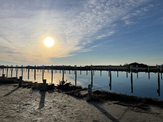 Fototapeta premium Sunset on the sea, sky, sea, lagoon, briccola. The briccola to indicate the waterways in the Grado lagoons. Grado, island of the sun. Tourist marine. Grado Pineta boat mooring. 