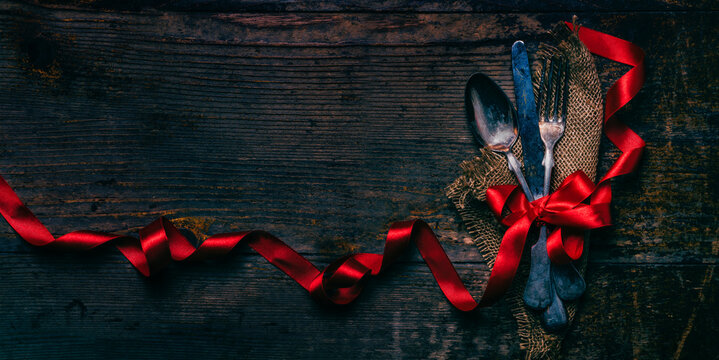 Valentines Dinner Background With Vintage Silverware And Red Ribbon On Wooden Table. Luxury Restaurant Menu For Romantic Celebration Event. Valentine Day Dine. Top View.