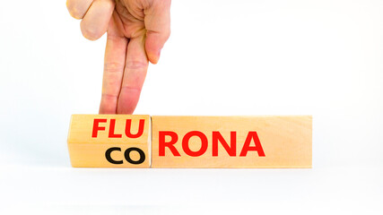 Covid-19 corona and flu flurona symbol. Doctor turns cubes and changes the word corona to flurona. Beautiful white background. Medical, covid-19 corona and flu flurona concept. Copy space.