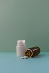 White pills (medicine) spilling out of a brown bottle - obrazy, fototapety, plakaty