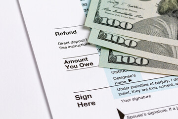 1040 individual income tax return form and money. Tax payment, filing taxes and financial planning...